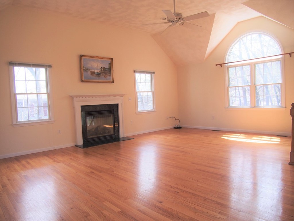 237 Allen Road Billerica, MA 01821 - Photo 8 of 22 an empty room with wooden floor fireplace and windows