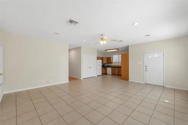 an empty room with a kitchen