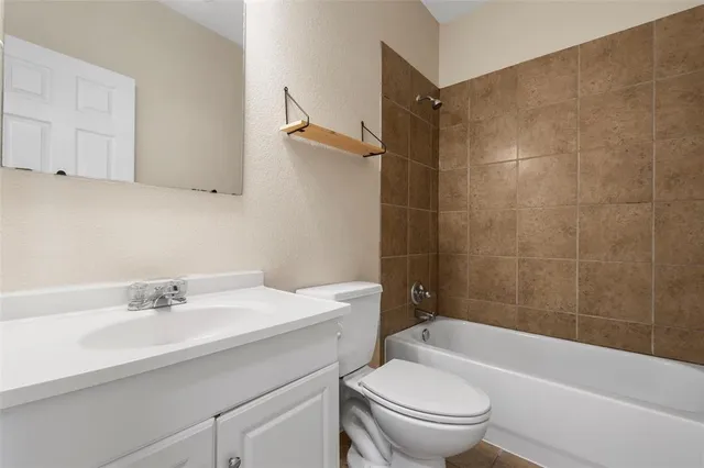 a bathroom with a sink a toilet and a bathtub