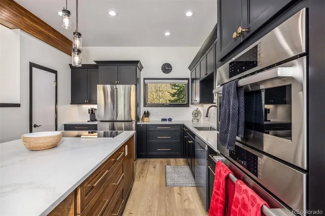 a open kitchen with stainless steel appliances granite countertop a stove and a refrigerator