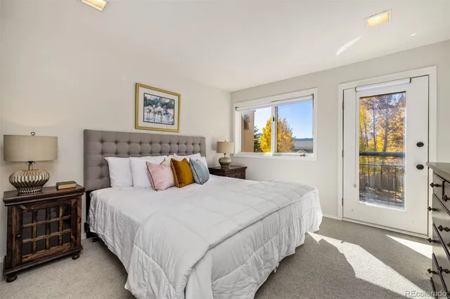 a bathroom with a granite countertop sink mirror vanity and toilet