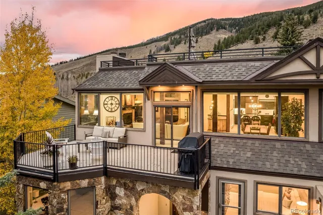 a balcony with table and chairs