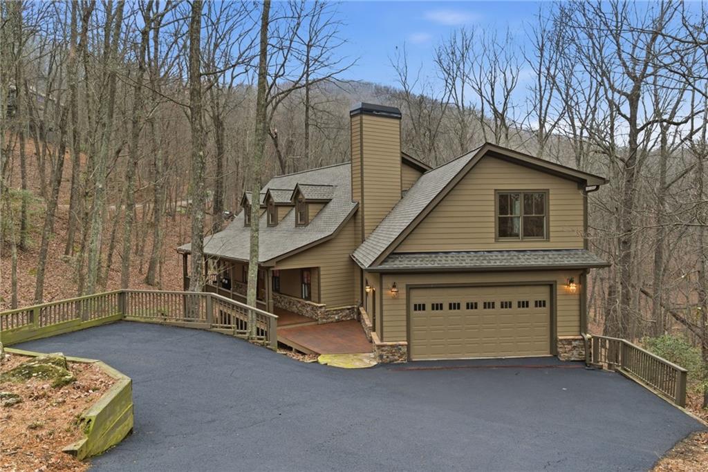11 Poplar Circle Big Canoe, GA 30143 - Photo 31 of 34 a view of a house with a yard and garage