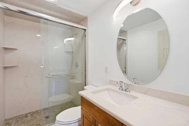 a bathroom with a sink toilet and shower
