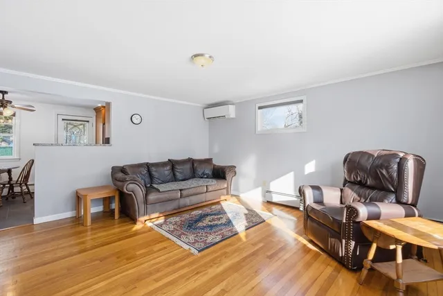 a living room with furniture and wooden floor