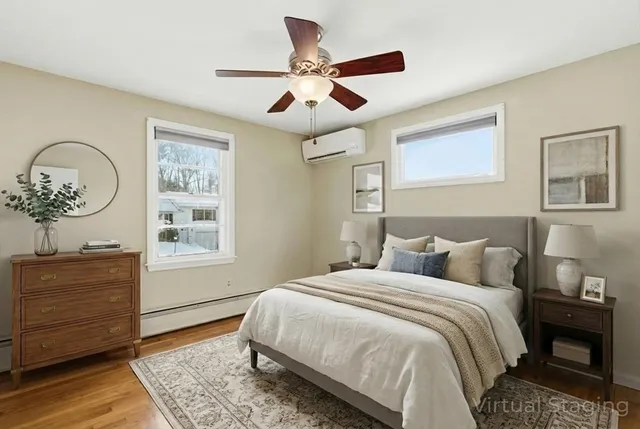 a bedroom with a bed a dresser and a window