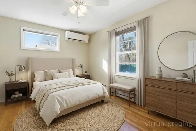 a bedroom with a bed a mirror and a window