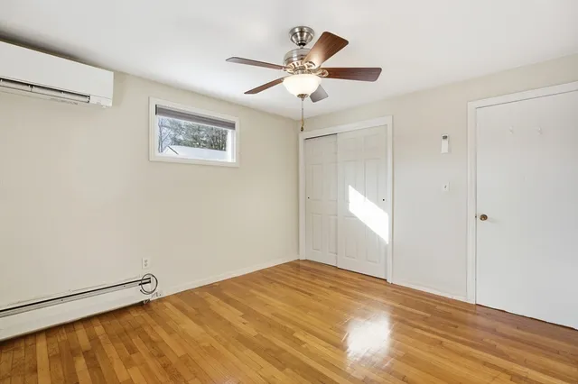 a view of a big room with wooden floor and windows in a room