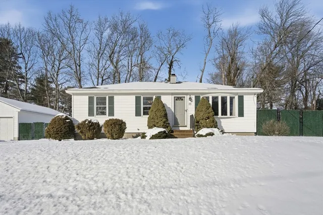 a view of a house with a yard covered in snow