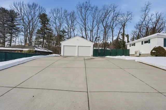 a white house that has a tree in front of it