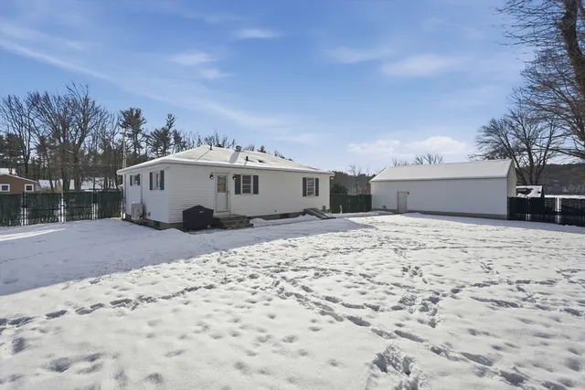 a view of a white house with a yard