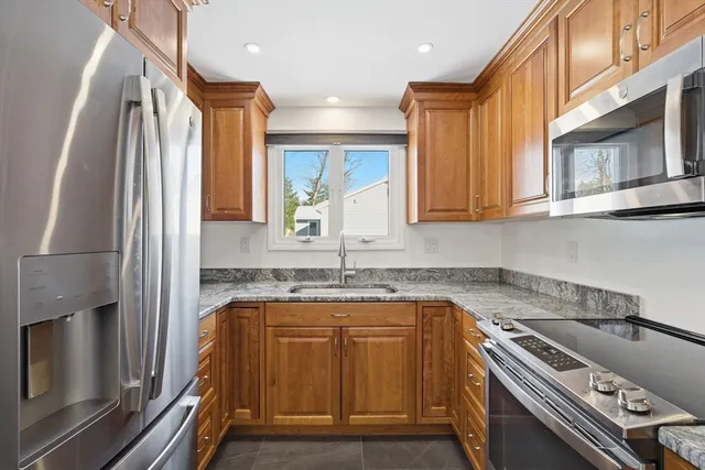 a kitchen with a sink appliances and cabinets