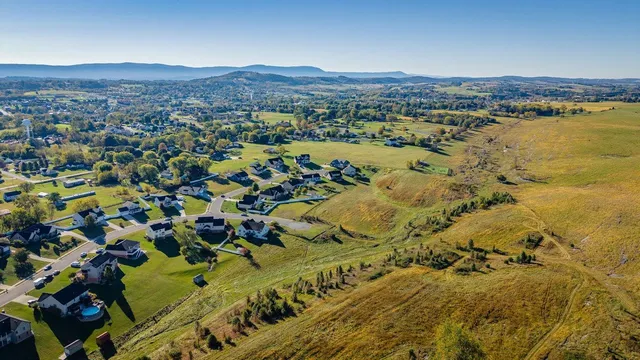 an aerial view of a house with a swimming pool