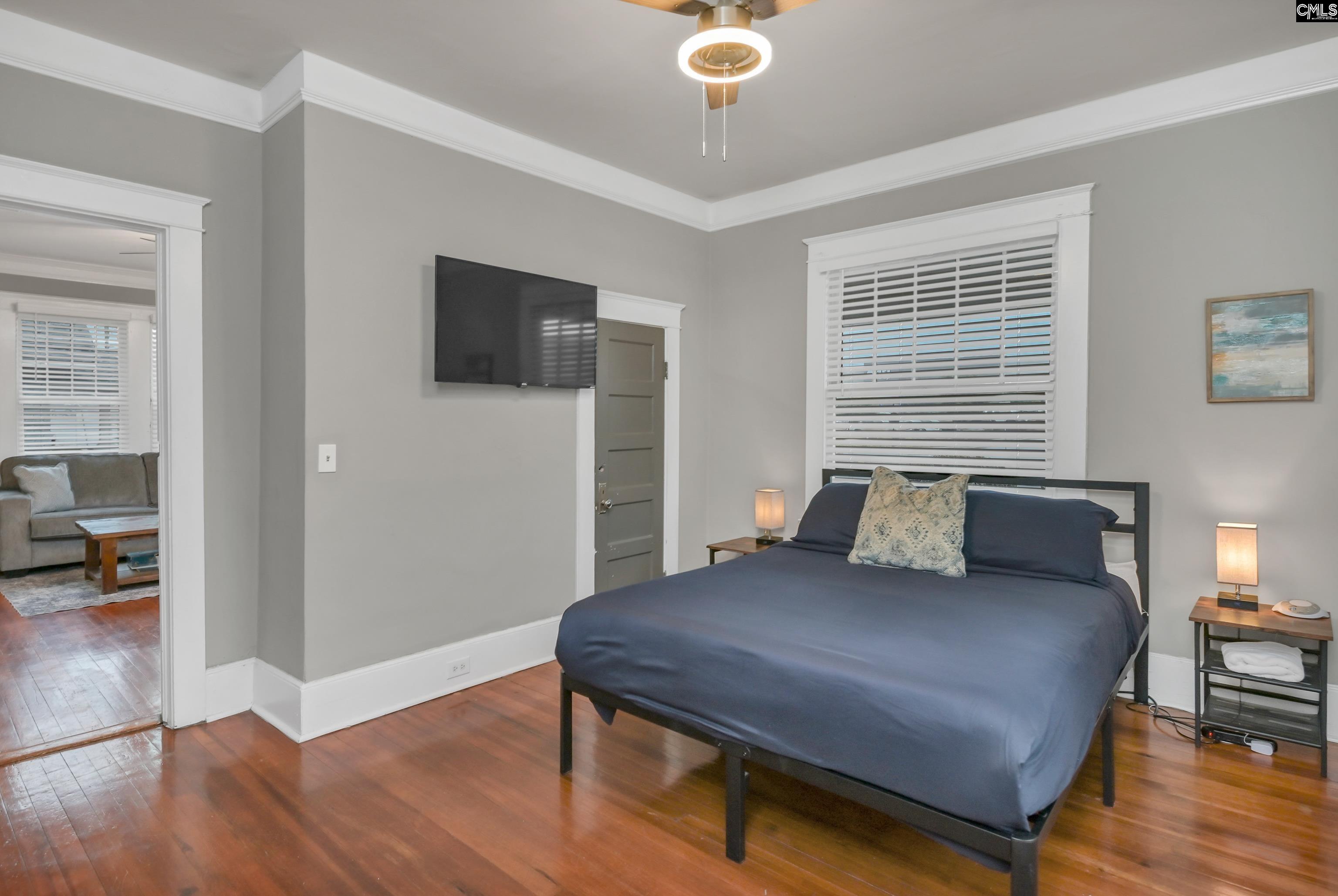 2227 Bull Street Columbia, SC 29201 - Photo 25 of 38 a living room with a bed and a flat screen tv