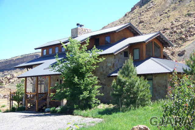 680 39 Road Palisade, CO 81526 - Photo 1 of 32 a front view of a house with a yard