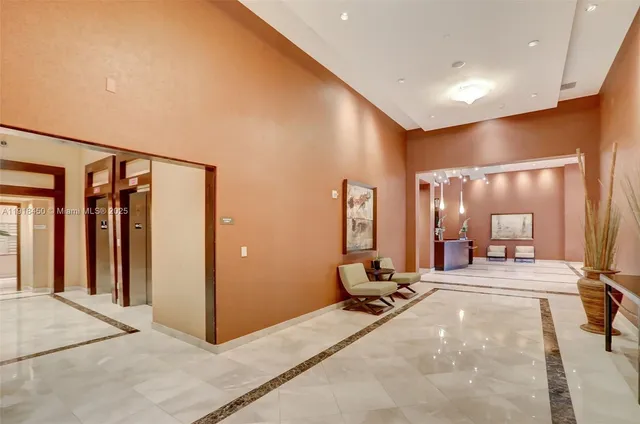 a view of a hallway with couches and dinning table