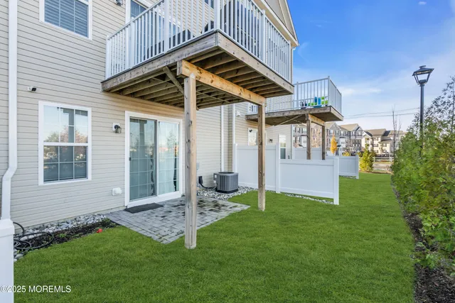 a view of a house with a yard patio and fire pit