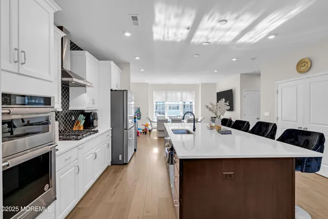 a large kitchen with a large counter top appliances and cabinets
