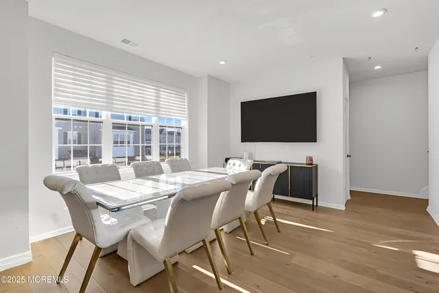 a dining room with furniture and wooden floor