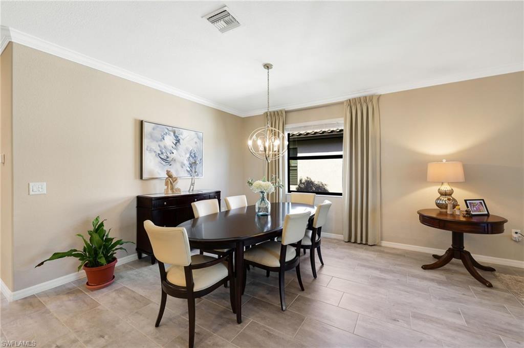 19724 The Pl Boulevard Estero, FL 33928 - Photo 12 of 36 a view of a dining room with furniture and wooden floor