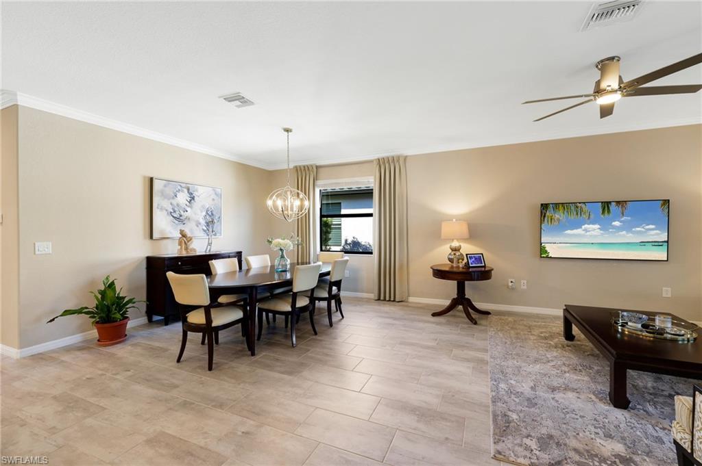 19724 The Pl Boulevard Estero, FL 33928 - Photo 17 of 36 a living room with furniture a dining table and a window