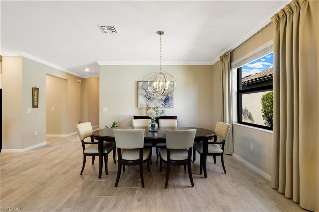 19724 The Pl Boulevard Estero, FL 33928 - Photo 20 of 36 a view of a dining room with furniture window and wooden floor