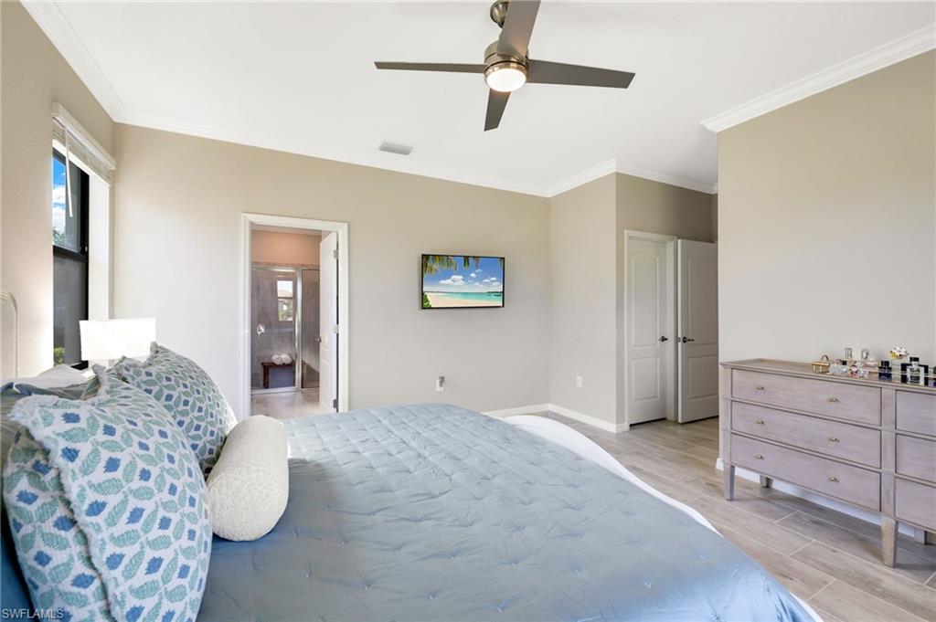 19724 The Pl Boulevard Estero, FL 33928 - Photo 22 of 36 a bedroom with a large bed and a couch