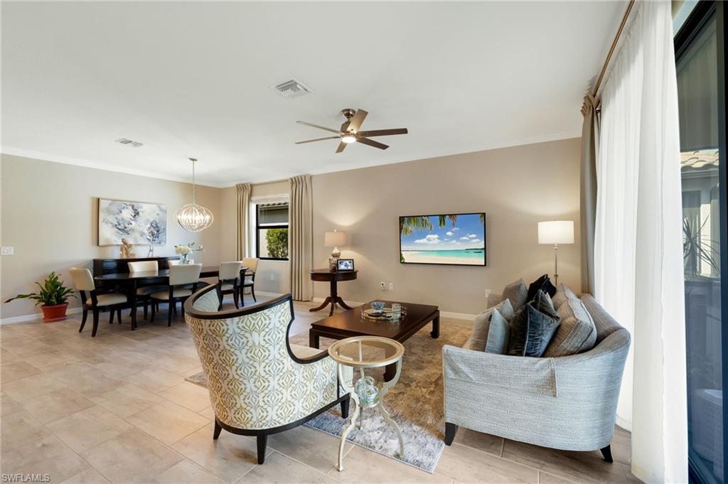 19724 The Pl Boulevard Estero, FL 33928 - Photo 25 of 36 a living room with couches a computer and a window with wooden floor
