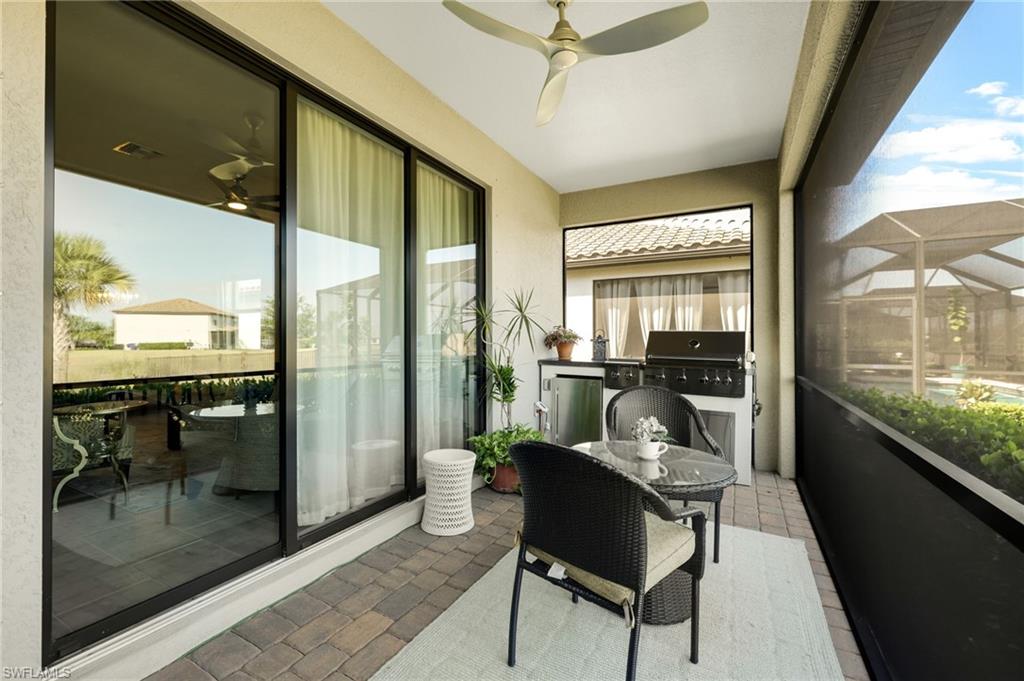 19724 The Pl Boulevard Estero, FL 33928 - Photo 35 of 36 a living room with furniture and a floor to ceiling window