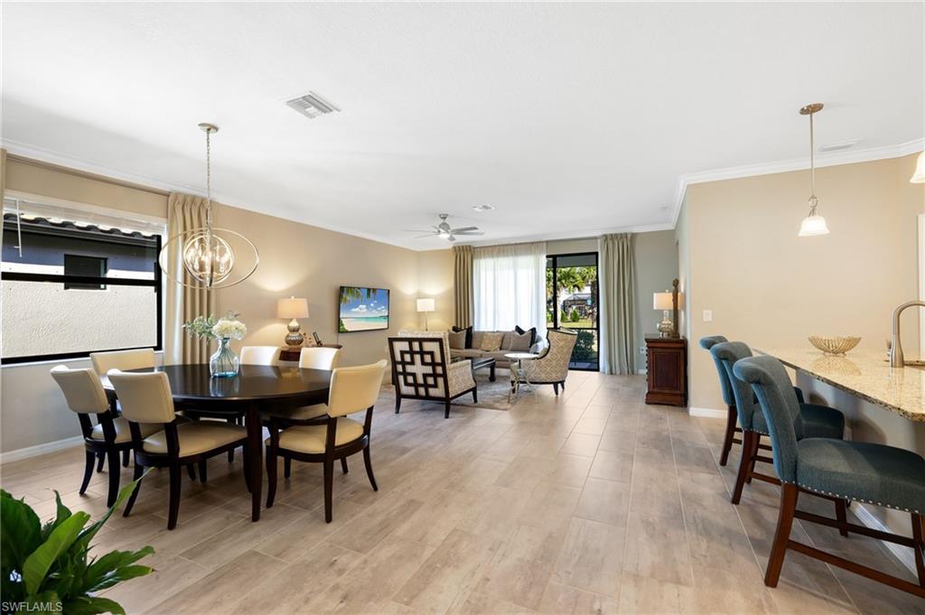 19724 The Pl Boulevard Estero, FL 33928 - Photo 7 of 36 a view of a dining room with furniture and wooden floor