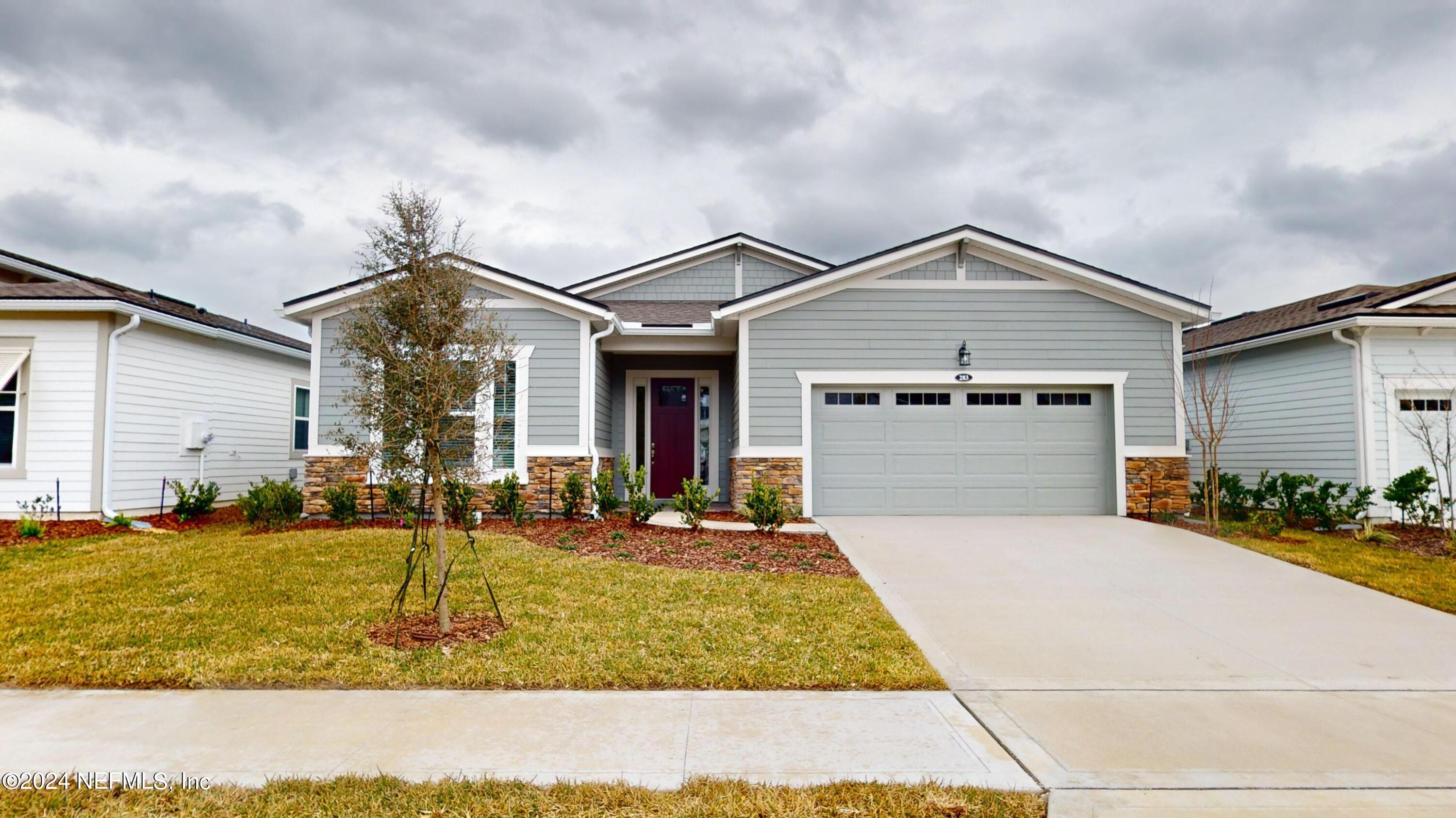 283 Pinellas Way St. Johns, FL 32259 - Photo 1 of 71 a front view of a house with a yard outdoor seating and garage