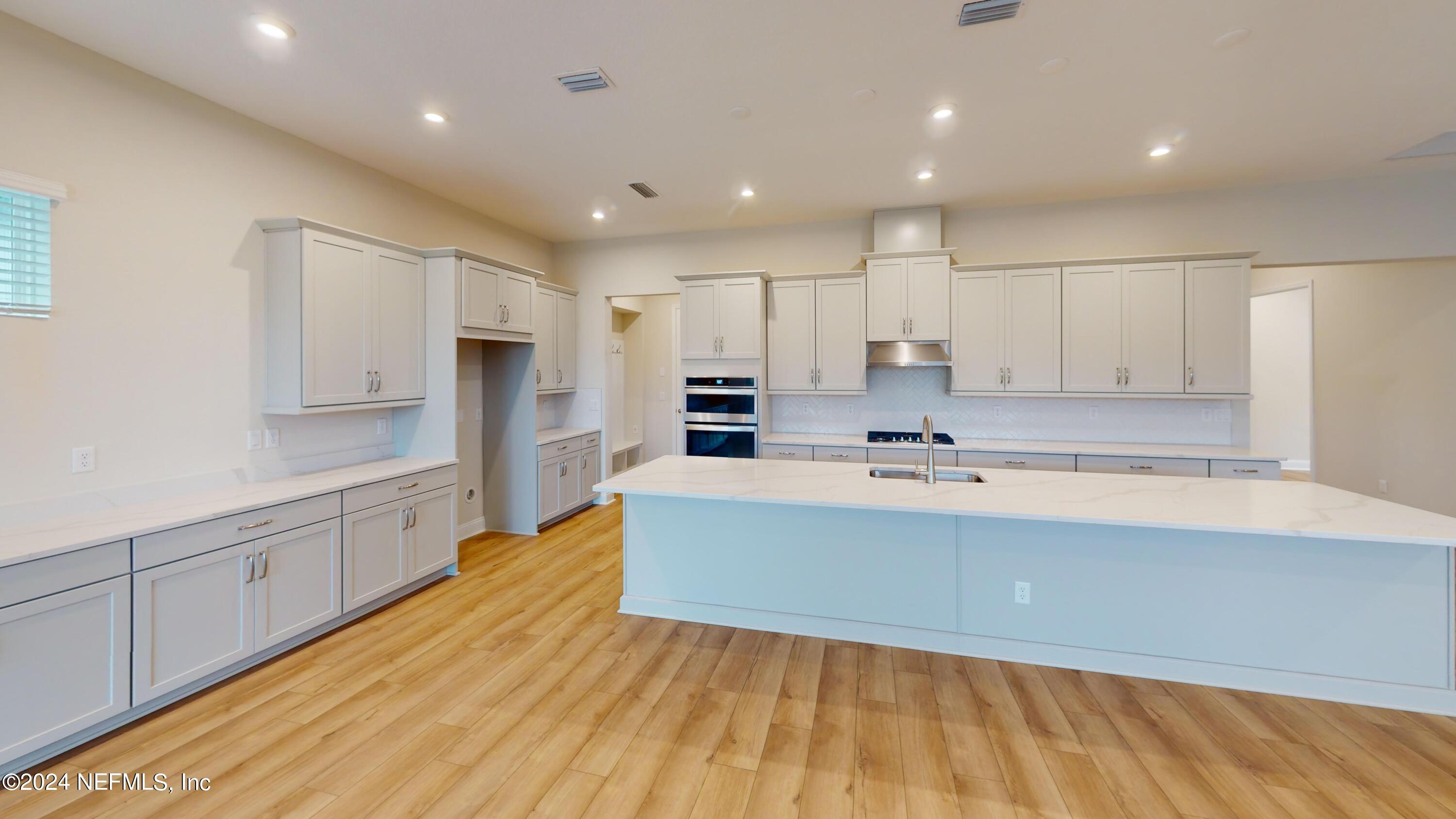 283 Pinellas Way St. Johns, FL 32259 - Photo 12 of 71 a large kitchen with kitchen island a sink stainless steel appliances and cabinets