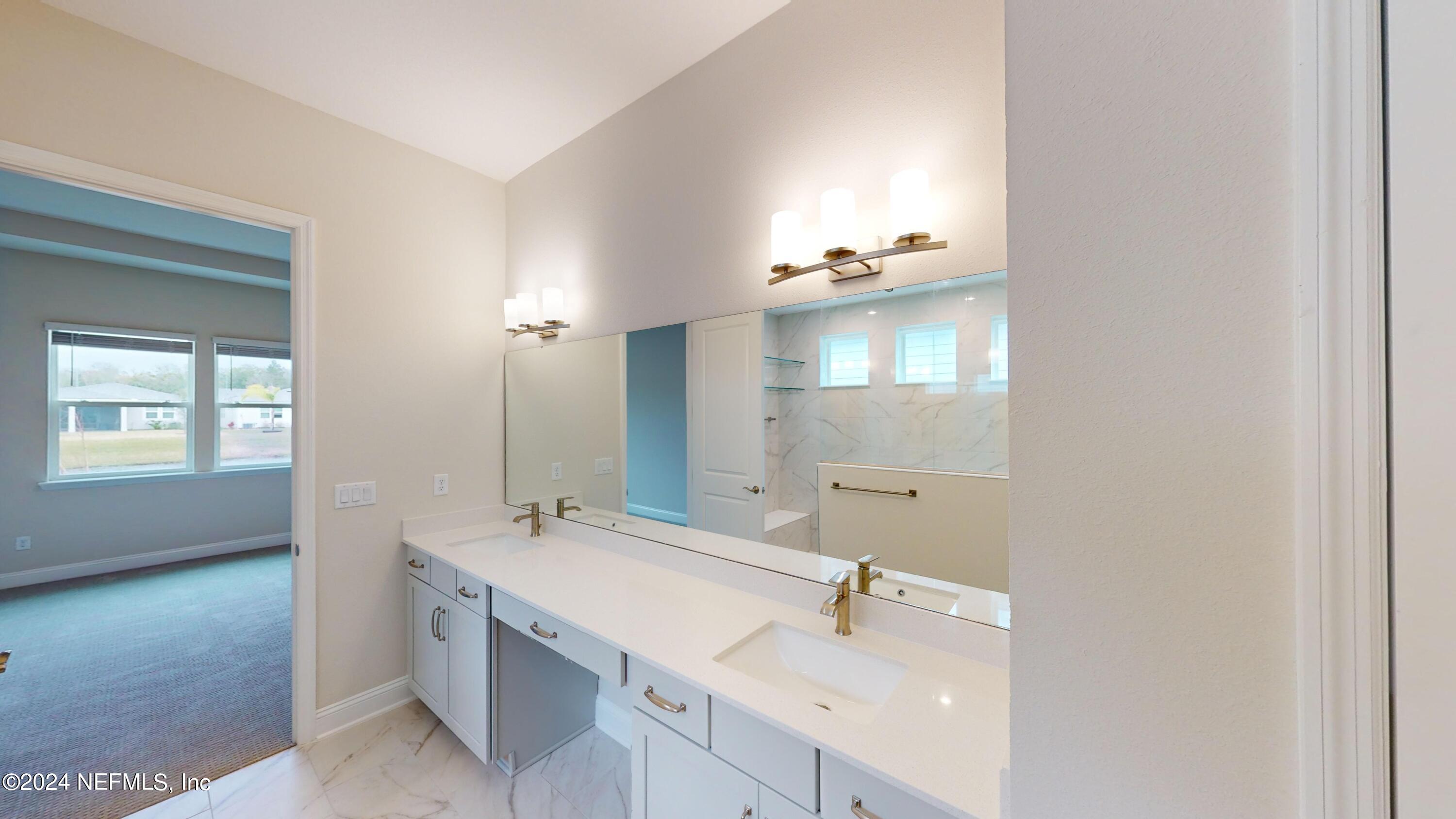 283 Pinellas Way St. Johns, FL 32259 - Photo 17 of 71 a bathroom with a double vanity sink and mirror