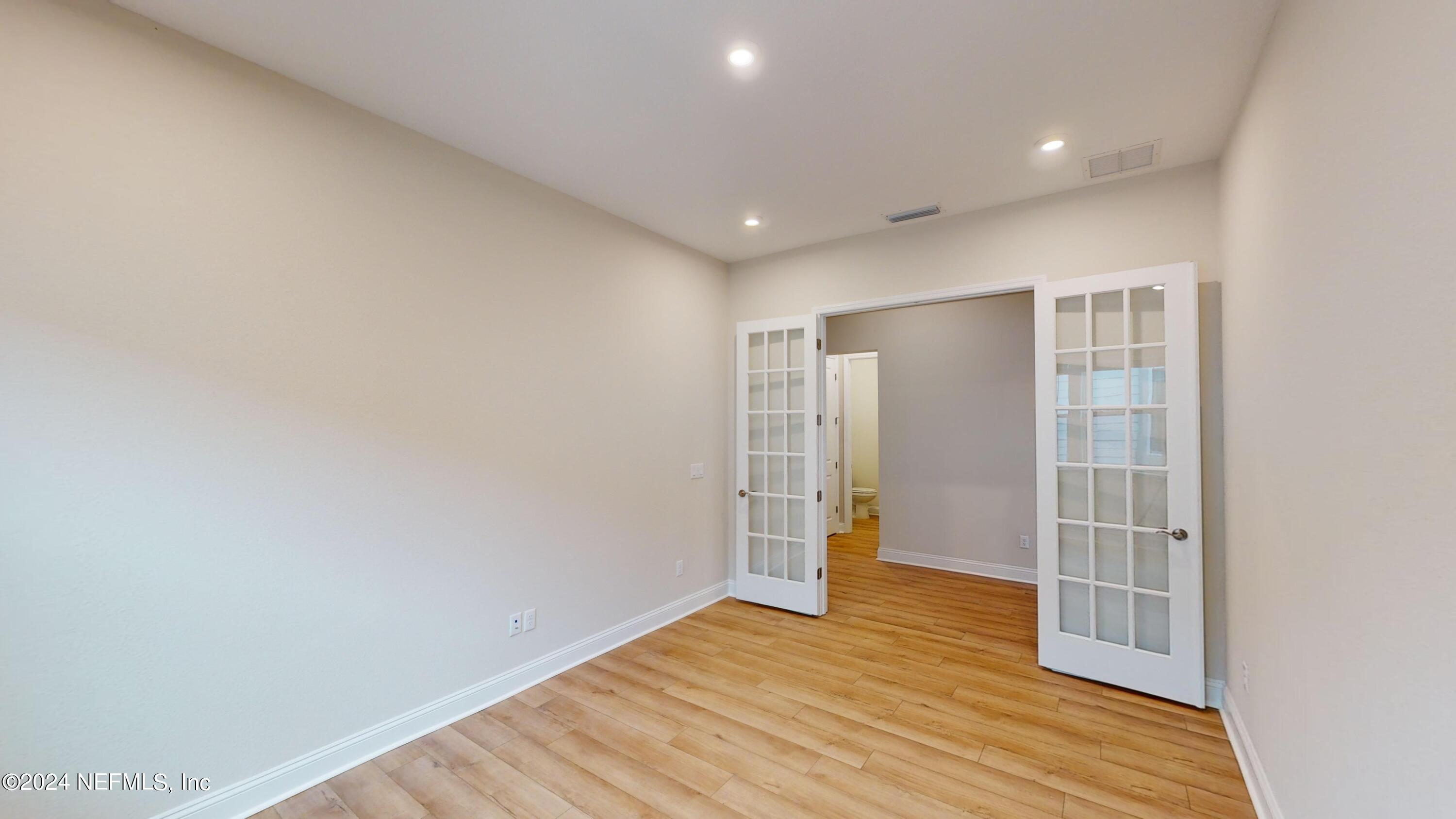 283 Pinellas Way St. Johns, FL 32259 - Photo 8 of 71 a view of an empty room with wooden floor and entryway