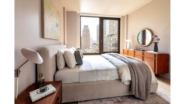 a bedroom with bed and a window