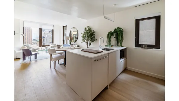 a living room with furniture and large windows