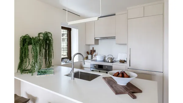 a very nice looking living room with a large window and dining table