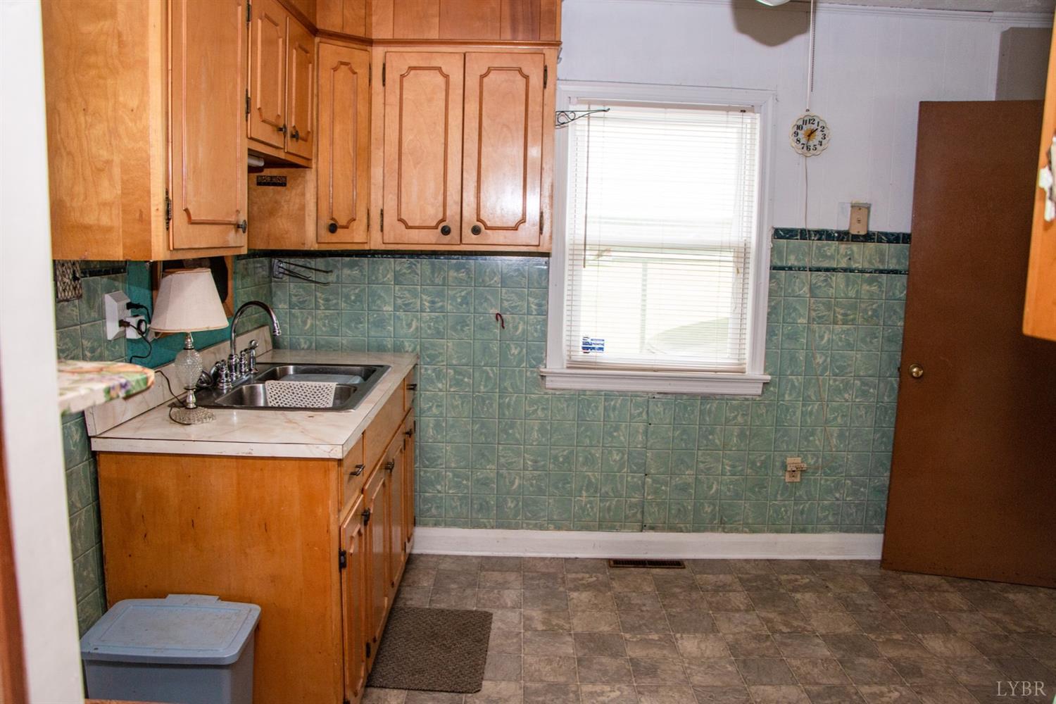 296 Pamplin Road Pamplin, VA 23958 - Photo 9 of 23 a bathroom with a sink a mirror and a window