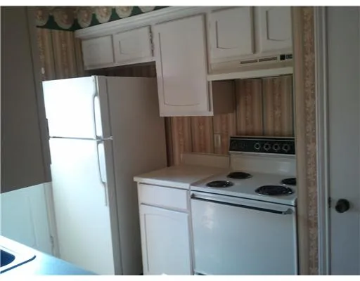 a kitchen with a refrigerator and a cabinets