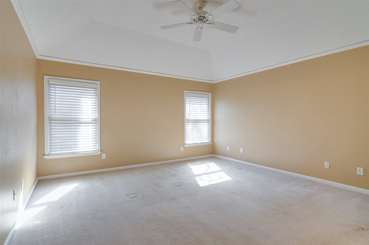 420 Meadvale Road Memphis, TN 38120 - Photo 12 of 25 The downstairs primary suite is spacious and features a vaulted ceiling.