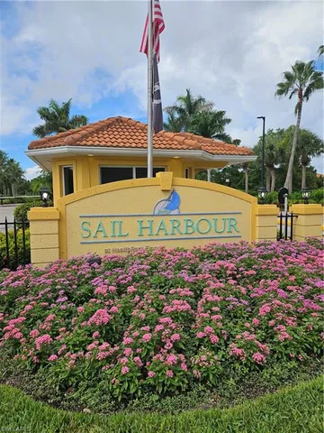 a view of a house with a yard and potted plants