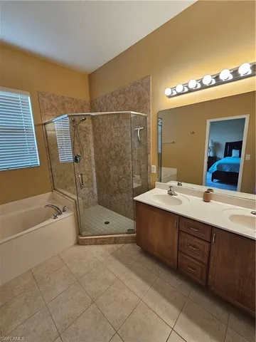 a bathroom with a double vanity sink and a mirror