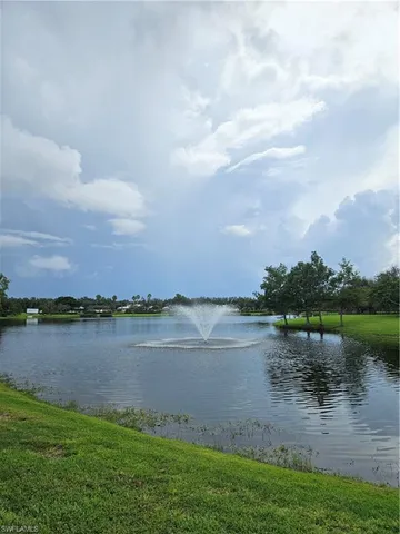 a view of a lake with houses in the back