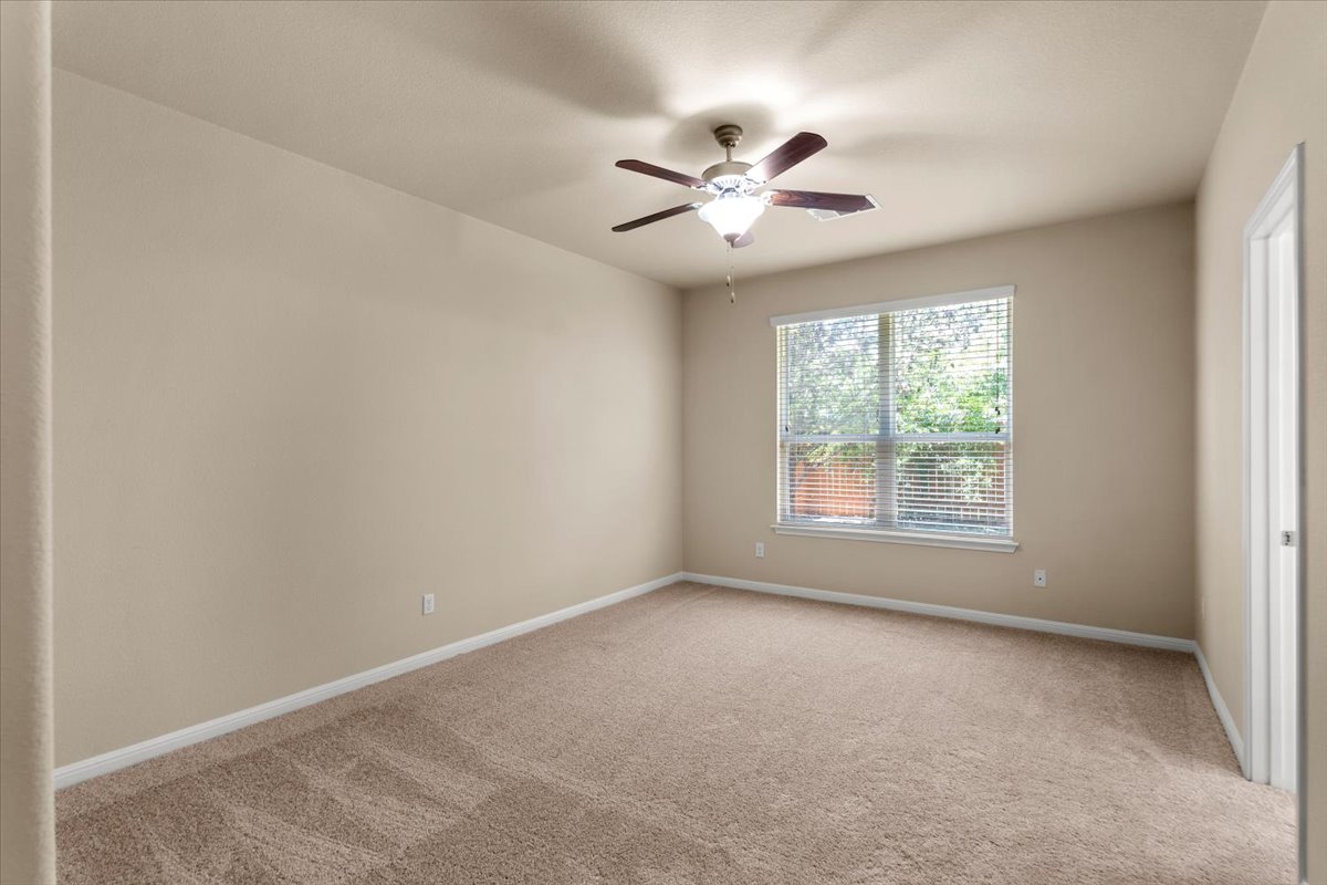 3451 Mayfield Ranch Boulevard, Unit 311 Round Rock, TX 78681 - Photo 19 of 40 Spacious room featuring neutral carpeting, light-toned walls, and a ceiling fan with integrated lighting