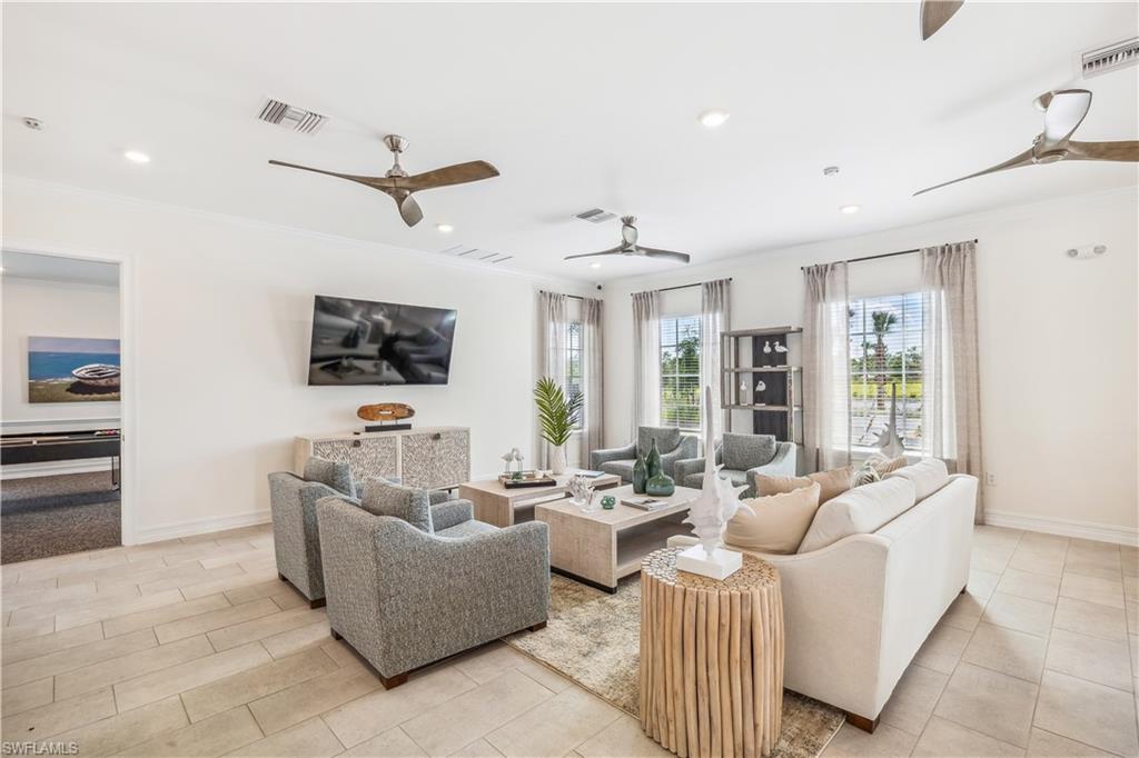 17737 Shade Tree Loop Punta Gorda, FL 33982 - Photo 3 of 28 Tiled living room featuring ceiling fan and ornamental molding