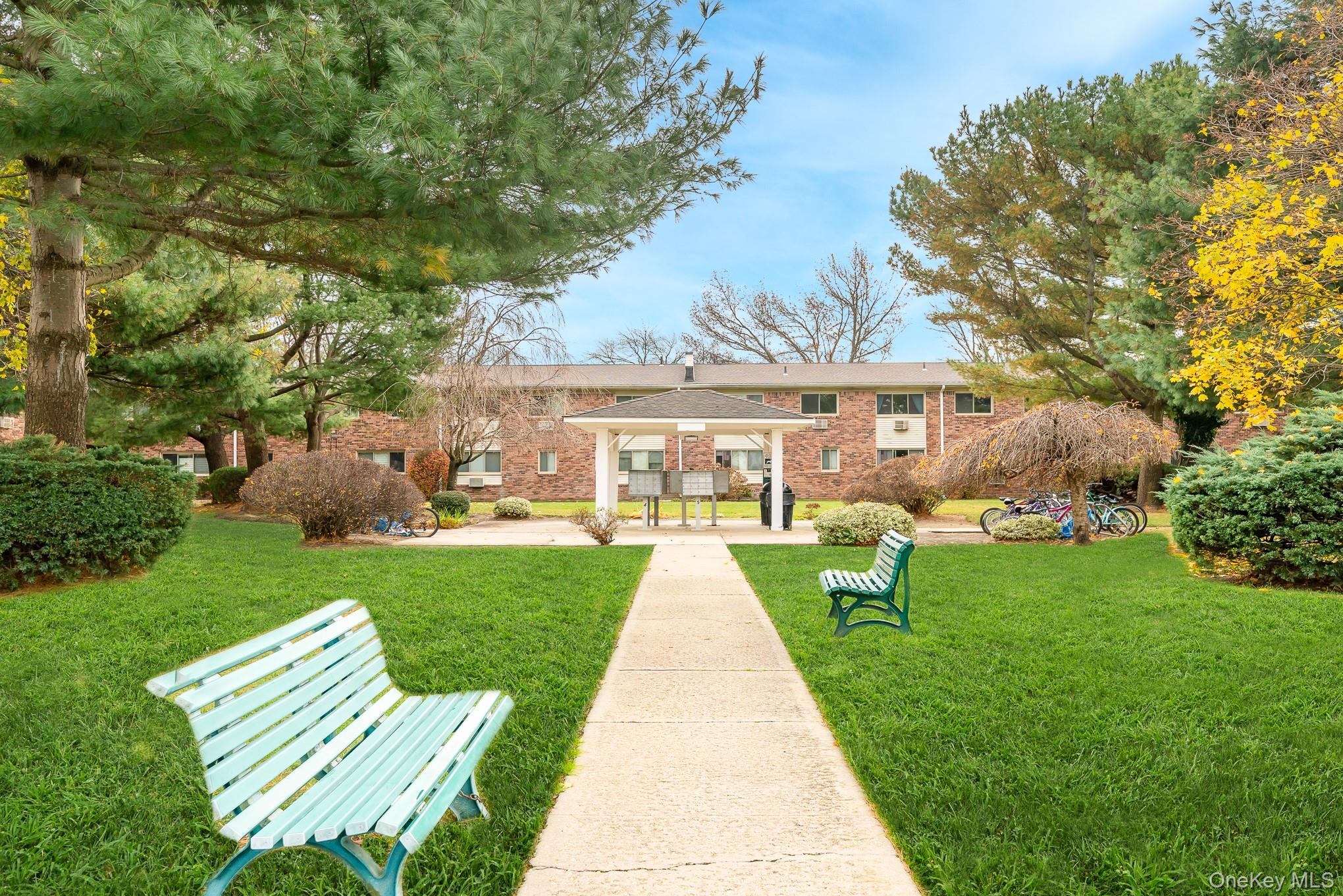 2449 F Union Boulevard, Unit 12A Islip, NY 11751 - Photo 2 of 16 Back of property with a patio area, a gazebo, a yard, and brick siding