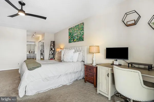 a bedroom with a bed window and a desk
