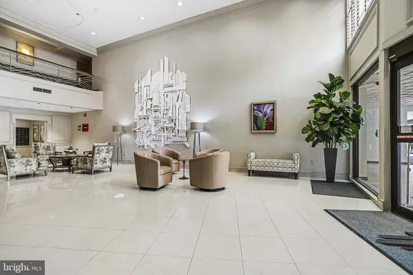 a living room with furniture and potted plants
