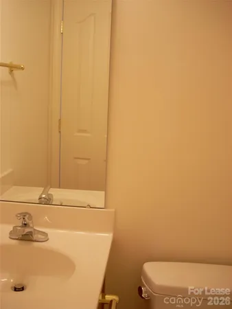 a bathroom with a sink a toilet and mirror