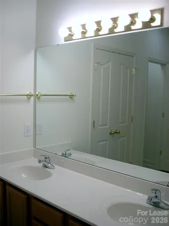 a bathroom with a sink and mirror